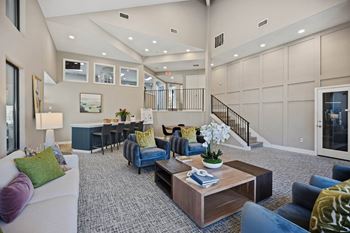 a living room with furniture and a staircase